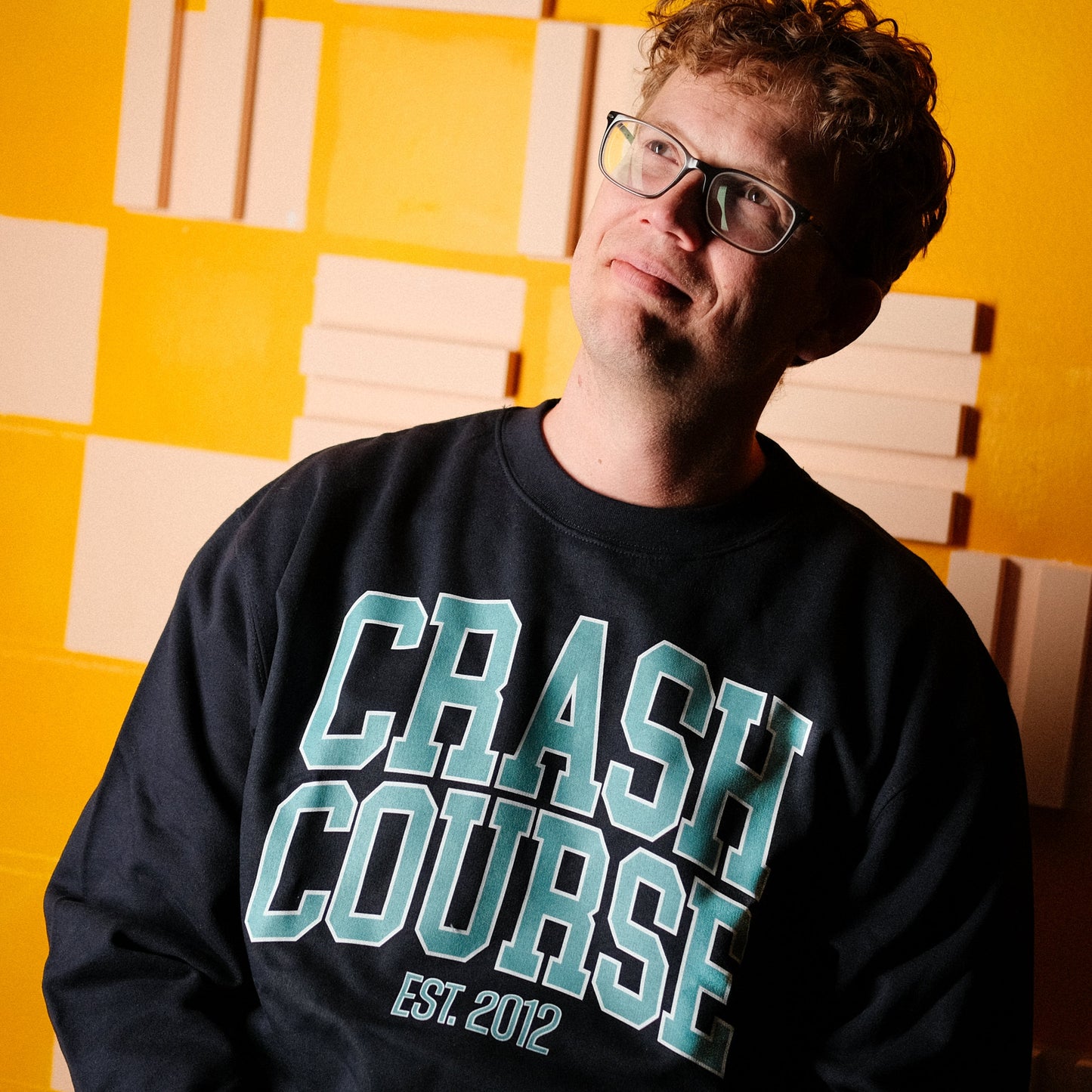 Hank Green wearing a university style navy blue sweatshirt