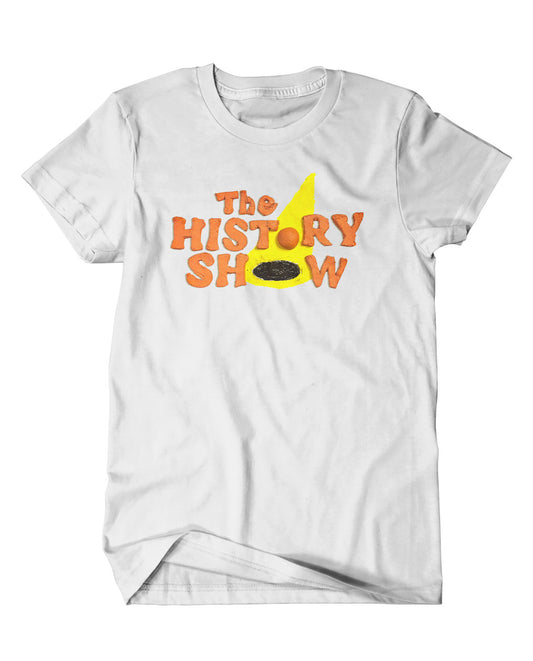 A mockup of an off-white t-shirt with a design featuring a handmade version of the History Show logo. The text has been sculpted in orange clay and the spotlight drawn in yellow and black.
