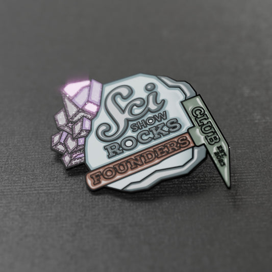 The SciShow Rocks Founder's Club pin features filled enamel with shiny glitter in the purple crystals