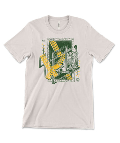 A mockup of an off-white t-shirt with a graphic in green and yellow featuring various alchemical symbols. From SciShow.